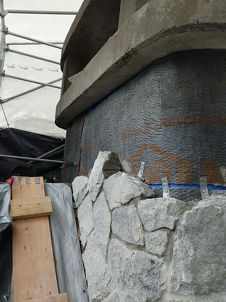 Stone cladding with rainscreen and building wrap